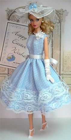 a barbie doll wearing a blue dress and hat