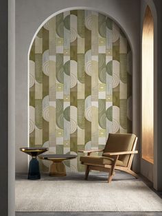 a chair and table sitting in front of a wallpapered room with arched doorway