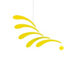 a yellow wind chime hanging from a string on a white background with an orange ball in the foreground