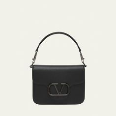 Valentino Garavani "Loco" shoulder bag in leather and metal  Detachable top handle  Detachable, adjustable crossbody strap Can be worn as a top handle or crossbody bag  Flap top with tonal VLOGO magnetic closure  Interior, one slip pocket  Lining: Leather Approx. 6.3"H x 8.7"W x 2.8"D Made in Italy Designer Flap Bag With Adjustable Strap, Designer Shoulder Bag With Detachable Strap For Everyday Luxury, Modern Flap Bag With Top Handle And Branded Hardware, Luxury Shoulder Bag With Detachable Strap And Round Handle, Designer Tote Flap Bag With Branded Hardware, Luxury Shoulder Bag With Adjustable Strap And Round Handle, Designer Flap Shoulder Bag With Detachable Strap, Designer Shoulder Bag With Round Handle And Adjustable Strap, Designer Satchel With Round Handle