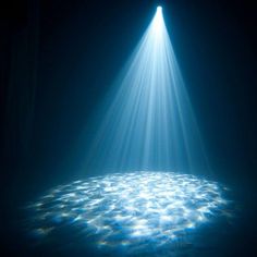 the light shines brightly over an ocean floor covered in blue water with bubbles on it