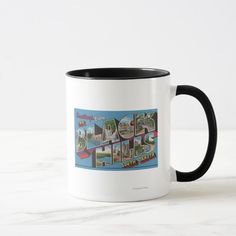 a white and black coffee mug sitting on top of a marble counter topped with an image of the city of los angeles