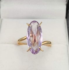 1970s 18K gold ring set with an important marquise cut amethyst Measuring 17.9 x 8.1 x 5.2 mm the amethyst weighs approx 3.75 Ct It is set in 4 prongs on a slightly crossover shank giving a very minimalist look letting the gemstone being the show Weight of the ring : 2.9Gr Size : US 7 1/2 - UK P - FR 56 It is possible to resize this ring for a flat fee of 40 euros equivalent. Please allow 6-10 working days for the modification to be done as we do not perform the alteration ourselves but use the Gold Marquise Amethyst Ring For Wedding, Gift Marquise Amethyst Ring In Yellow Gold, Gold Amethyst Marquise Cut Ring For Anniversary, Yellow Gold Marquise Amethyst Ring As Gift, Gold Marquise Cut Amethyst Ring For Anniversary, Gift Yellow Gold Marquise Amethyst Ring, Yellow Gold Marquise Amethyst Ring For Anniversary, Formal Gold Marquise Cut Amethyst Ring, Purple Marquise Cut Amethyst Ring For Formal Occasions