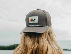 Get ready to make a statement with the Wetland Snapback. In stylish dark grey with a matching grey mesh, this hat is perfect for any occasion. But what really sets it apart is the new 'loon' rubber patch and funky rope accessory. So go ahead, stand out from the crowd and add a little fun to your wardrobe. - 60% Cotton 40% Polyester - One size - Spot clean recommended - Designed in Minnesota - Imported Retail: $30 Gray Curved Bill Hat For Summer, Adjustable Charcoal Hat For Outdoor, Adjustable Charcoal Hat With Curved Brim, Gray Trucker Hat With Short Brim For Outdoor, Adjustable Flat Brim Hat With Mesh Back, Adjustable Mesh Back Hat With Flat Brim, Rubber Patch, Go Ahead, Fitted Hats