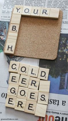 scrabble tiles spelling out words on newspaper