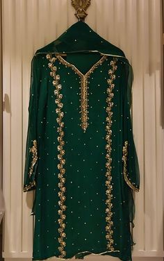 Pure chiffon dip dyed in poison green, with intricate handwork in dabka,sitara,naqshi,gotah and nug ( crystal stones ). Paired with matching trousers and dupatta. Delivery Time: 4 to 6 weeks Green Churidar With Mirror Work, Green Churidar With Mirror Work In Traditional Drape, Green Churidar With Mirror Work For Navratri, Green Mirror Work Churidar For Navratri, Designer Green Churidar With Mirror Work, Festive Green Gota Work Churidar, Elegant Green Sharara With Gota Work, Green Traditional Churidar With Sheer Dupatta, Traditional Green Churidar With Sheer Dupatta