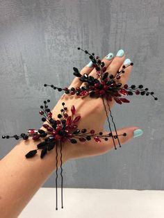 a woman's hand with black and red flowers on it