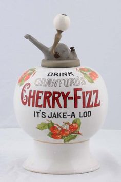 a ceramic jar with a snail on it's top that says cherry - fizz, it's lake - a - loo