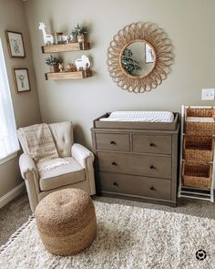 a baby's room with a crib, dresser and mirror on the wall