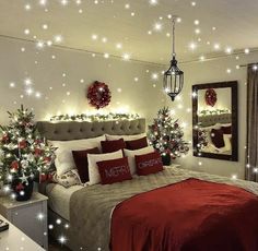 a bedroom decorated for christmas with red and white decorations on the walls, lights around the bed