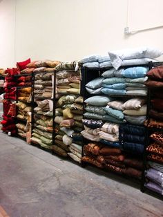 stacks of folded and unpacked clothes in a warehouse