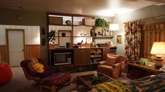 a living room filled with lots of furniture and decor on top of carpeted flooring