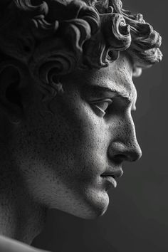 a black and white photo of a man's head with curly hair in profile