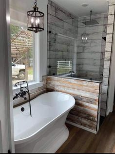 a white bath tub sitting next to a window