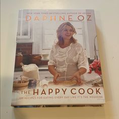 the happy cook book is sitting on a table