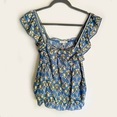 New With Tags Sleeveless Blouse From Max Studio, Size M Medium. Blue Polyester Floral Print Of Iris Flowers In An Art Deco Style. Ruffle Strap And Waist With Slight Gathering At Bust. Machine Wash Cold, Gentle Cycle. Measures 18" At Bust (Laid Flat), 16" At Waist (Unstretched, Laid Flat), 22" From Shoulder To Hem. Smoke- And Pet-Free Home. Casual Summer Blouse With Ruffled Straps, Summer Floral Print Tank Top With Ruffled Straps, Sleeveless Summer Blouse With Ruffles, Sleeveless Ruffled Summer Blouse, Floral Print Top With Ruffled Straps For Summer, Casual Blue Ruffled Tank Top, Blue Floral Print Tank Top For Summer, Blue Sleeveless Floral Print Top, Blue Floral Print Sleeveless Top