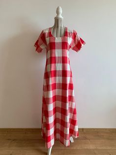 "This is a beautiful vintage cotton red and white white checkered dress with short sleeves and scoop neck. This cottage core maxi dress is made of lovely check print cotton fabric which is perfect for the summer season. As it was handmade, there is no label to show the materials or size. The fabric feels like cotton or could be linen/cotton blent. It has no stretch. This romantic bohemian style dress has a simple a line silhouette. There is no size marked on this bohemian dress, it fits like size S M. Please check the measurements below.  The belt does not come with the dress. It can be purchased separately here - https://www.etsy.com/listing/1548547229/vintage-80s-red-leather-waist-belt-rope?click_key=f206803bf793a66e012d62fae8636080087152f1%3A1548547229&click_sum=30732eeb&ref=shop_home_a Retro Short Sleeve Plaid Gingham Dress, Vintage Style Gingham Plaid Short Sleeve Dress, Vintage Gingham Plaid Dress With Short Sleeves, Vintage Gingham Plaid Dress For Summer, Vintage Summer Plaid Dress For Picnic, Vintage Short Sleeve Plaid Cotton Dress, Square Neck Cotton Plaid Dress, Vintage Short Sleeve Plaid Dress For Spring, Vintage Plaid Short Sleeve Dress For Spring