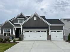 a large house with two garages in front of it