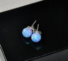 Shop Cornflower Blue Opal Earrings Sterling Silver, 6 mm Ball Opal Stud Earrings, Opal Jewelry Blue opal ball earrings are very light! They will bring a perfect touch of flair and splash of magnificent colors to your outfit! Opal is an ideal gift as the birthstone for October. Your order will arrive in a nice box ready to be given. Stud earrings are made from: - Gorgeous blue lab created half drilled ball opal beads -6 mm - Solid 925 Sterling Silver post You'll get sterling silver stoppers and s Blue Opal Earrings, Earrings Opal, Piercing Ideas, Opal Earrings Stud, Opal Studs, Jewelry Images, Earrings Blue, Opal Earrings, Cornflower Blue