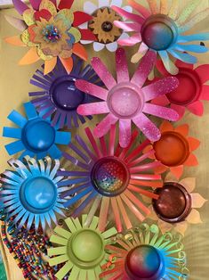 colorful paper flowers are arranged on a table