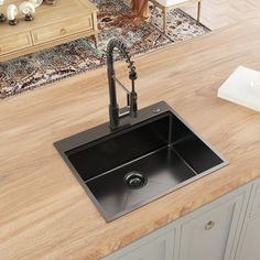 a kitchen sink sitting on top of a wooden counter next to a rug and cabinets