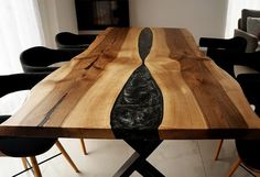 a wooden table with black chairs around it