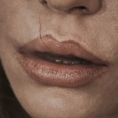 a close up shot of a person's face with makeup smeared on the lips