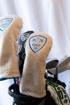 two golf gloves sitting on top of a bag