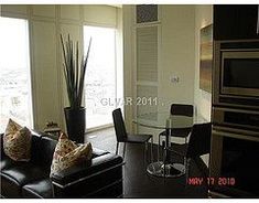 a living room filled with furniture next to a window