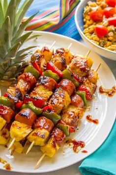 skewered pineapples and vegetables on a white plate