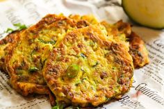 three fritters sitting on top of a piece of paper