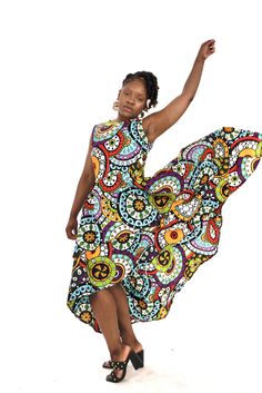 A woman posing in a bright multi-colored African print high-low maxi dress. Sunny Season, Formal Parties, Ankara Print, African Ankara, Layered Dress, Layer Dress, High Low Hem, African Print, Multi Layering