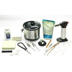 the contents of a crock pot are shown with scissors, spoons and other items