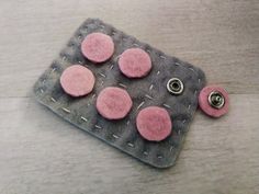 pink and grey felt with buttons attached to it