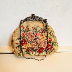 This antique petit-point handbag is made with a richly worked bracket, a unique silver frame model. Ideal for presentations, and events, this bag is just throwing you back in the good old style. The purse interior has one compartment with one small pocket and is made of pink fabric and the small chain and clasp are made of silver. Has old hallmarks; the total weight is 200 grams. Measures: The chain is: 40 cm long,  Width: 20 cm / 7.8 inches, Height: 18 cm / 7.0 inches.  All the items in our sho Silver Hallmarks, Silver Purse, Frame Model, Purse Handmade, Handmade Purses, Vintage Interiors, Vintage Purse, Unique Antiques, Old Style