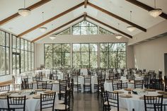 tables and chairs are set up for an event in a large room with high ceilings