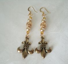 "These beautiful earrings have gold plated filigree beads, glass pearl beads, seed beads and brass fleur de lis charms. 2.5\" long from hook bottom." Antique Gold Earrings With Historical Design, Victorian Gold Plug Earrings, Ornate Gold Earrings With Historical Design, Ornate Historical Design Earrings, Gold Earrings With Historical Design For Wedding, Ornate Historical Drop Earrings Jewelry, Ornate Historical Drop Earrings, Ornate Historical Design Drop Earrings Jewelry, Gold Victorian Baroque Earrings