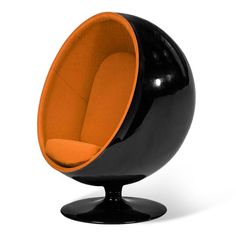 an orange and black ball chair sitting in front of a white background