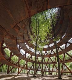 the inside of a circular structure with trees in it