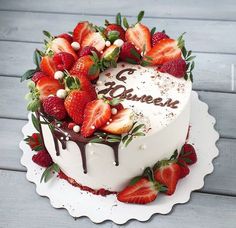 a heart shaped cake with strawberries on top