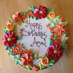 a birthday cake decorated with flowers and the words happy birthday are written in frosting