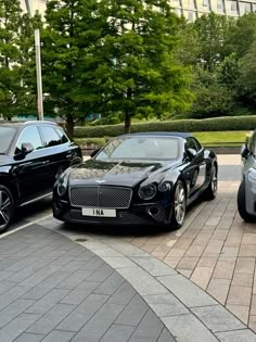 three luxury cars parked in a parking lot