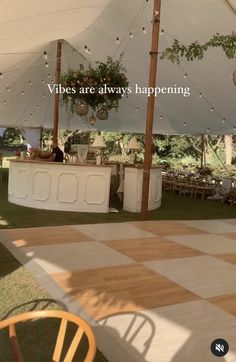 a large white tent with tables and chairs under it that says vibes are always happening