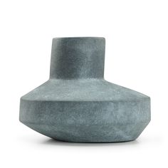 a gray vase sitting on top of a white surface