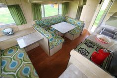 the interior of a mobile home with green and blue furniture