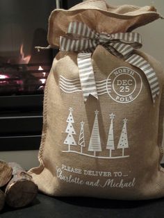 a burlock bag sitting on top of a table next to logs and a fire place