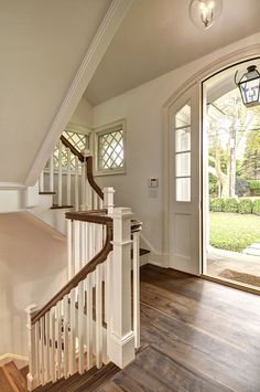 the stairs in this house are white and wood