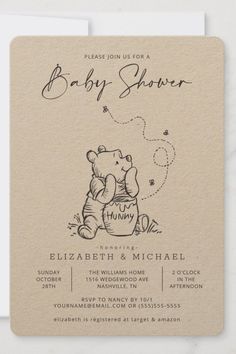 a baby shower with a teddy bear sitting in a bucket on it's belly