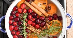 cranberry oranges, cinnamon sticks and spices in a pot on the stove