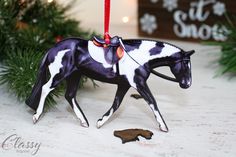 a black and white horse ornament hanging from a christmas tree